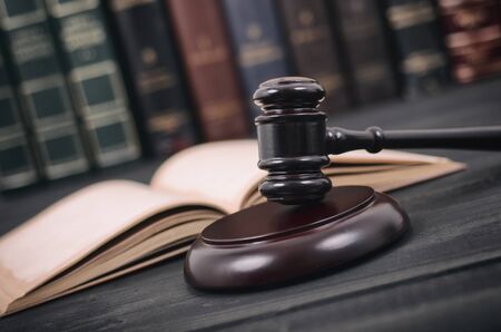 Law and Justice , Legality concept, Judge Gavel and law book on a black wooden background, law...