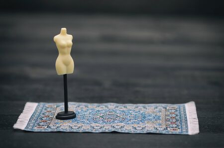 Fashion design concept, vintage mannequin stand on black wooden backgroundの写真素材