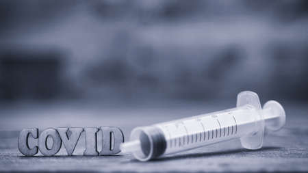 Coronavirus 2019-nCoV wooden letters stock photo. Epidemic virus Respiratory Syndrome stock photo. Corona virus outbreak. Stock photo of holding tube with Blood Test(novel Coronavirus 2019 disease,COVID-19,nCoV) blue tonedの写真素材