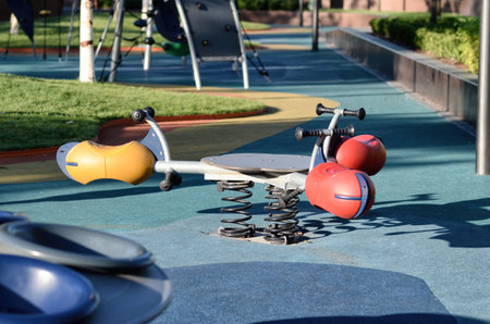 Spring toy riders , rocker toy riders in a children's public playground with rubber flooring
Modern playground with colorful rubber flooring for Children.の写真素材