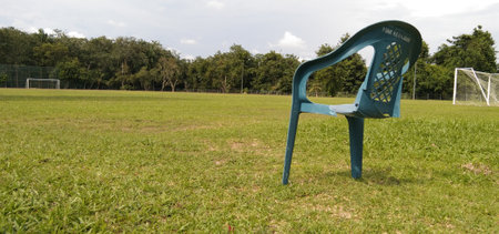the mystery of a chair floating in the middle of a football fieldの写真素材