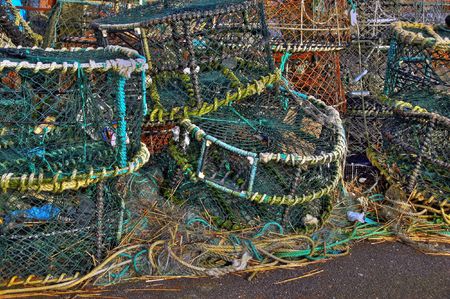 Lobster pots stacked on quayside in winter timeの写真素材