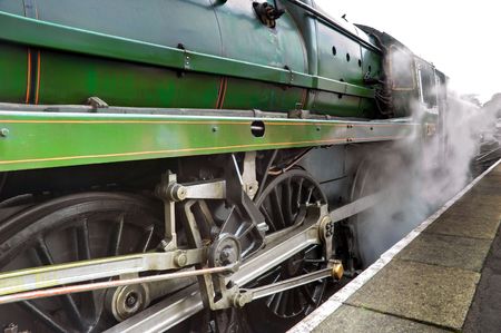 Old steam train engine releasing steam at alton stationの写真素材