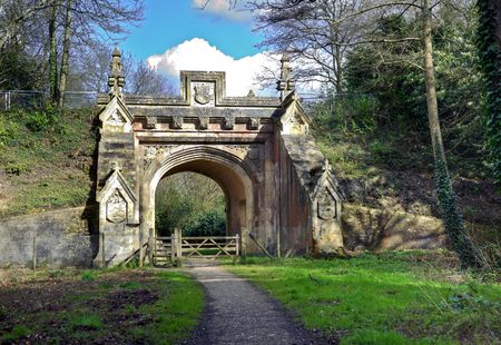 Peaceful walk leading to archway under old railway bridgeの写真素材