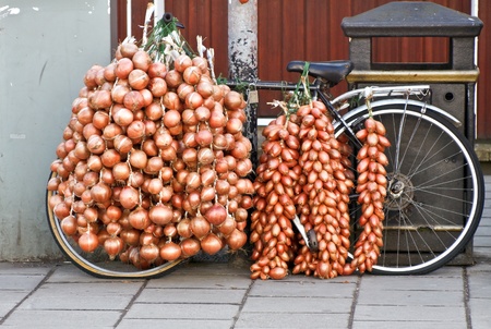 Bicycle loaded with fresh onions and shallotsの写真素材