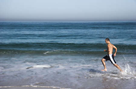 Man doing exercise in the beachの写真素材