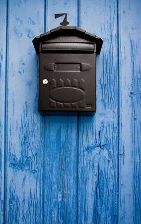 Mailbox in a blue doorの写真素材