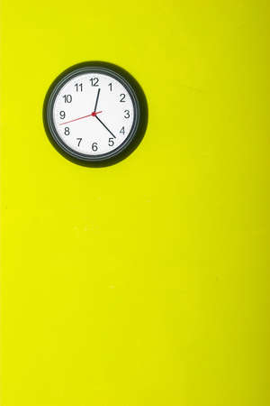 Clock in the green wallの写真素材