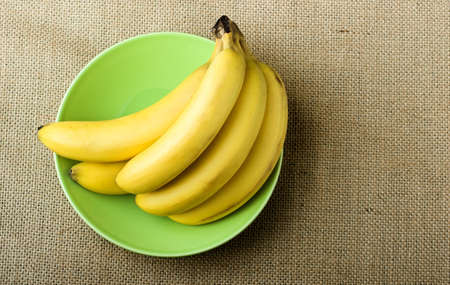 Bananas in a green plateの写真素材