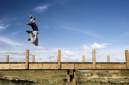 Young woman jumping for fun in a beautiful dayの写真素材