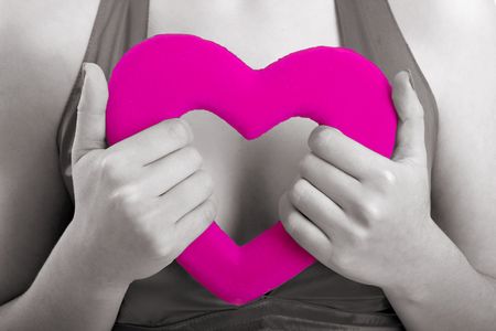 Woman holding a valentine hearth in the hands (partially desaturated in PS)の写真素材
