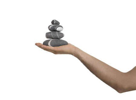 Small tower of balanced stones on man handの写真素材