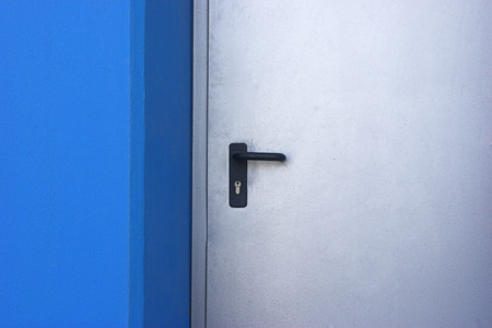 Picture of a door in a modern building with blue wallsの写真素材