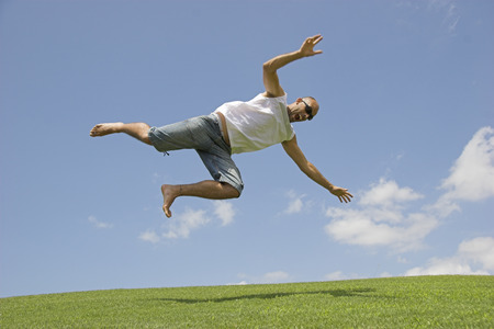 Man falling into the grass of a meadow