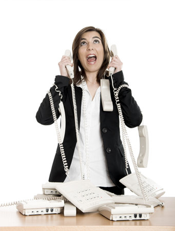 Busy woman working and answering a lot of calls at the same timeの写真素材