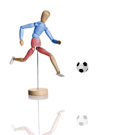 Colored wood toy playing football - isolated on white with reflectionの写真素材