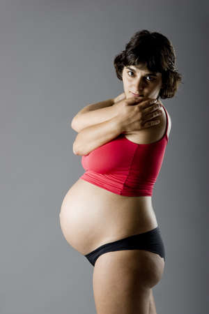 Studio portrait of a beautiful nine months pregnant woman