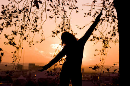 Beautiful Woman silhouette posing with open handsの写真素材