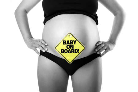 Nine Months Pregnant with a signal of  Baby on board on her tummyの写真素材