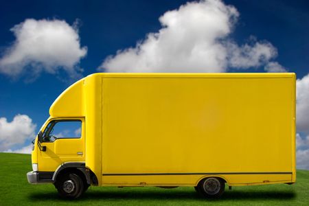 Yellow truck on a beautiful green meadow with copy space for textの写真素材