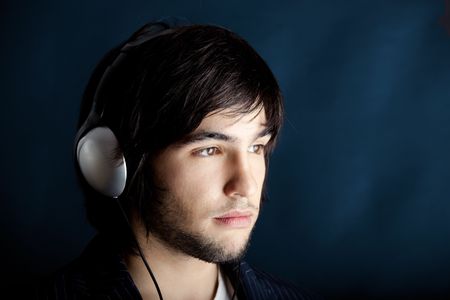 Young Man listening to music with headphones