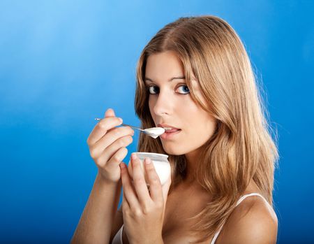 Portrait of Fresh and Beautiful young woman eating a yogurtの写真素材