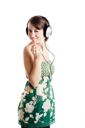 Beautiful young woman listen music and dancing with headphones, isolated on whiteの写真素材