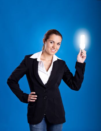 Portrait of a beautiful and young businesswoman holding a lightbulbの写真素材