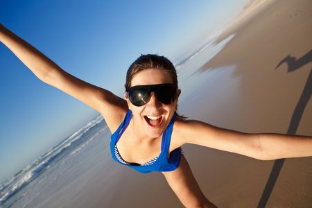 Beautiful young woman having fun on the beachの写真素材