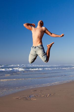 Young man jumping on the beach
