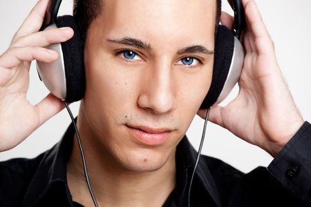 Portrait of a young man listening music with headphonesの写真素材