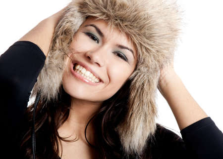 Adorable young woman with a beautiful smile and wearing a hatの写真素材
