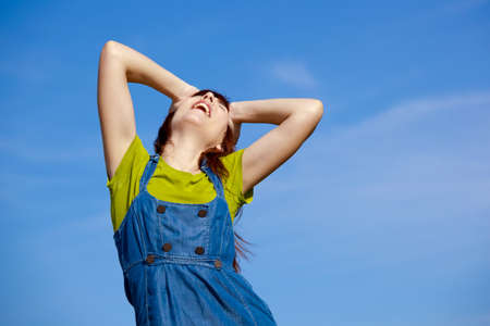 Portrait of a happy beautiful woman over a blue skyの写真素材