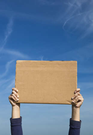 Female hands holding a blank paper cardの写真素材