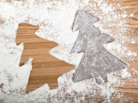Baking homemade Gingerbread cookies with a shape of a christmas treeの写真素材