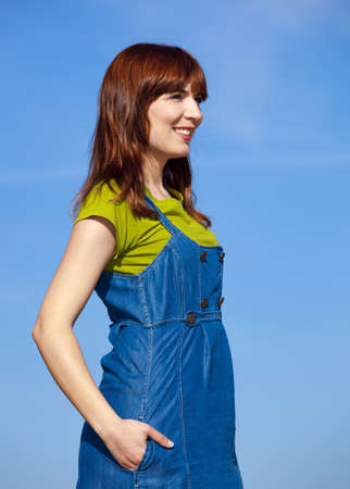 Portrait of a happy beautiful woman over a blue skyの写真素材