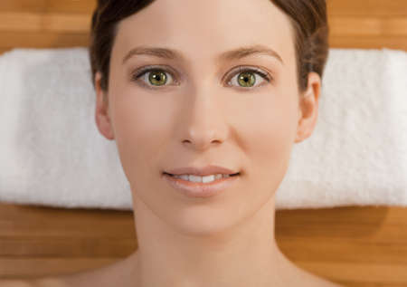 Portrait of beautiful young woman on a spa relaxed after a spa treatmentの写真素材