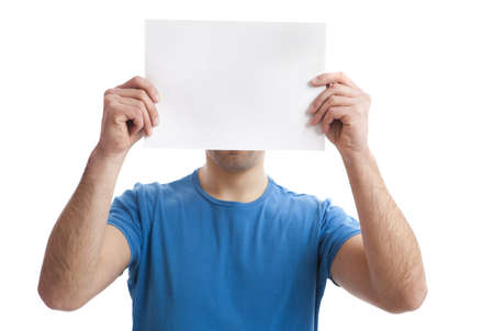 Young guy holding a blank bill board over face isolated on white の写真素材