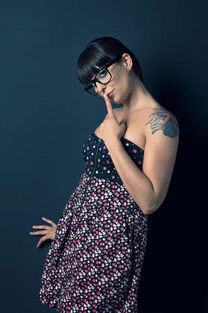 Portrait of a lovely woman with a vintage look against a grey background の写真素材