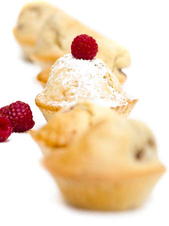 Muffins with raspberries isolated over a white backgroundの写真素材