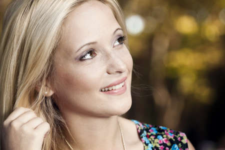 Outdoor portrait of a beautiful young girl smiling