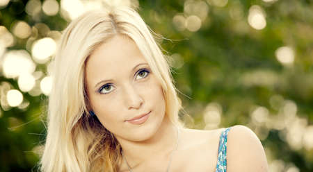 Outdoor portrait of a beautiful young woman in the park