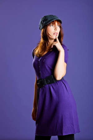 Portrait of a beautiful woman with a lovely espression, over a violet backgroundの写真素材