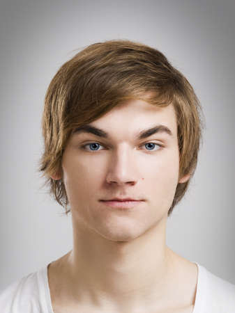 Portrait of a handsome young man, over a gray background