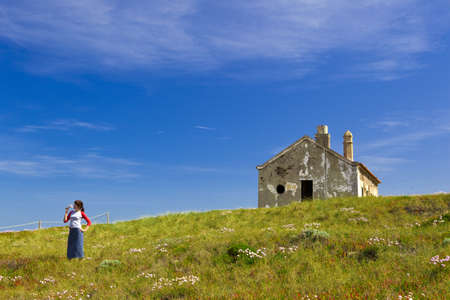 Young woman in a beautiful green meadow の写真素材