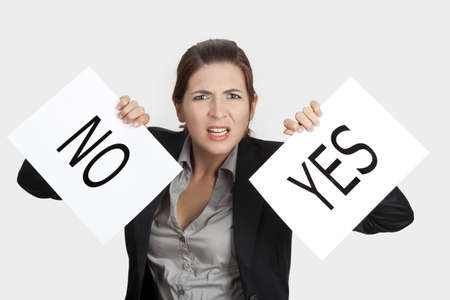 Business young woman trying to make a decision between Yes or No choiceの写真素材