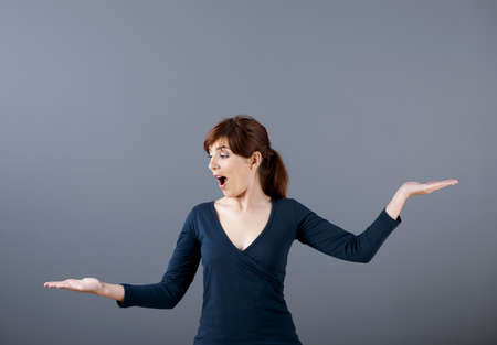 Woman making a scale with her arms の写真素材