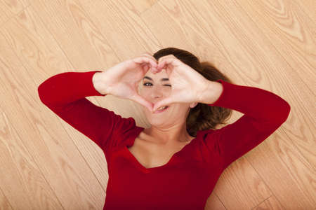 Beautiful woman playing with her ââhands and looking to the cameraの写真素材