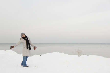 Beautiful woman enjoying a winter day full of snowの写真素材