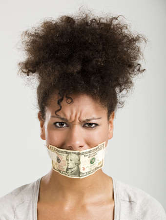 African American woman covering her mouth with a dollar banknote, great concept for the global crisesの写真素材